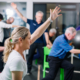Participants practicing balance exercises in a physiotherapy-led group session for neurological rehabilitation.
